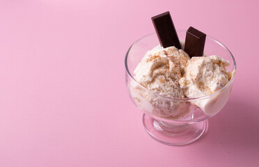 delicious creamy milky vanilla ice cream with caramel and chocolate addings in a glass container 