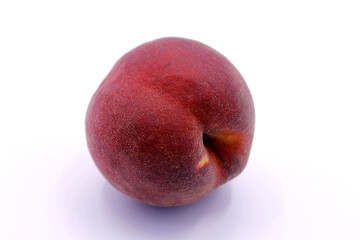 Ripe red peach close-up isolated on a white background.