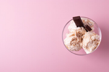 delicious creamy milky vanilla ice cream with caramel and chocolate addings in a glass container 