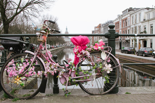 Flower-decorated bike next to canal
