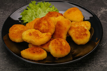 Fried chicken nuggets served salad leaves