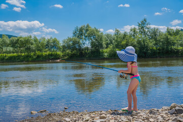 Little beautiful girl is fishing. Summer vacation, healthy lifestyle, sport concept.