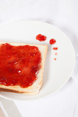 Spilled strawberry jam jelly on toast