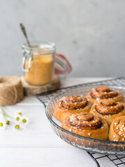 Freshly baked cinnamon buns with spices on a wooden background. Kanelbule - swedish dessert. Food concept. Rustic style