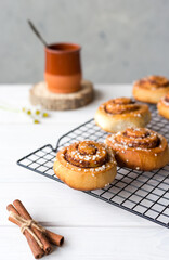 Freshly baked cinnamon buns with spices on a wooden background. Kanelbule - swedish dessert. Food concept. Rustic style