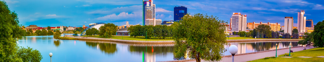 Fototapeta na wymiar Belarus Travel Destinations. Panorama of MInsk City With Trinity Suburb and Svisloch River in Background. Minsk is a Capital of the Republic of Belarus. Panoramic Image