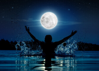 silhouette of happy woman raising arms in a swimming pool under the full moon, concept of carefree enjoyment and freedom