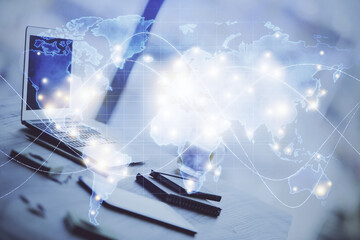 Double exposure of business theme icons and work space with computer background. Concept of success.