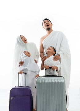 Happy Family Umrah Suprised While Looking Up. Hajj Asian Parent With Children Isolated Over White Background