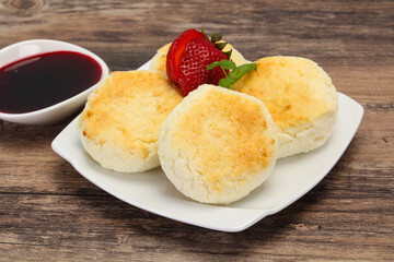 Curd pancakes with jam and stravberry