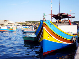 Fototapeta na wymiar The traditional Luzzu boats at Marsaxlokk, MALTA