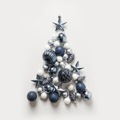 Christmas tree made of stars, blue balls on grey background. Xmas composition. Flat lay, top view. Holiday Greeting card. Happy New Year.