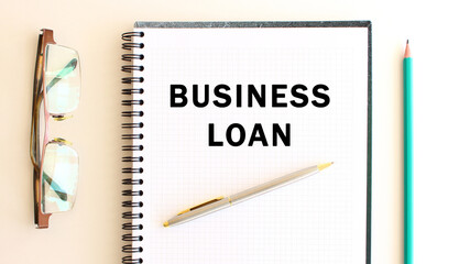 Notepad with text on a white background, near glasses and pencil. Business concept.