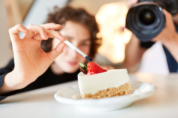 Stylist with brush and cake during food styling