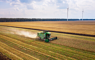 Harvesting machine working in the field. Top view from the drone.