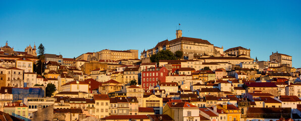 Old town of coimbra glows at night under a pretty summer sky, Portugal