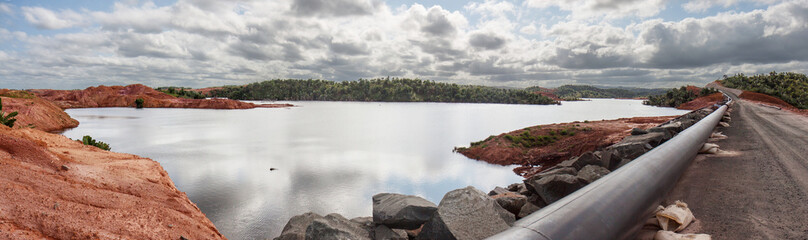 Mine tailings reservoir in Africa, receiving slurry through a pipeline from an ore processing plant.
