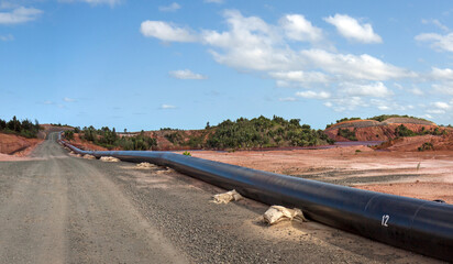 Mine tailings reservoir in Africa, receiving slurry through a pipeline from an ore processing plant.