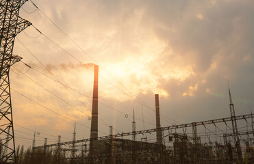 Fototapeta na wymiar Thermal power stations and power lines during sunset.