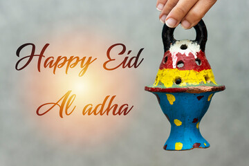 woman holding clay lantern. happy eid al adha concept