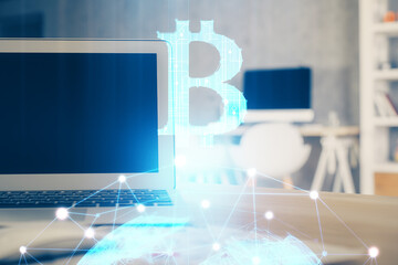 Multi exposure of blockchain theme hologram and table with computer background. Concept of bitcoin crypto currency.