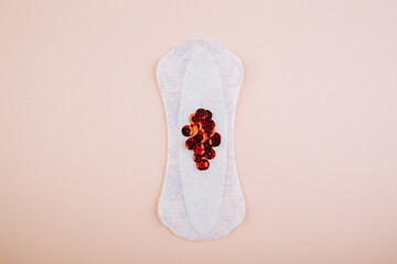 Menstrual pads with bright red glitter on pink background. Woman periods cycle, menstruation frequency. Minimalist still life photography concept.