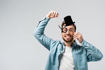 funny young man with fake hat and Pince-nez isolated on grey - obrazy, fototapety, plakaty