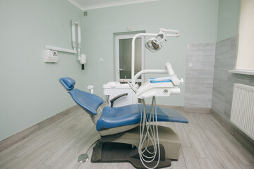 Modern dental practice. Dental chair and other accessories used by dentists in blue, medic light. Dentist Office, Dental Hygiene, Dentist's Chair
