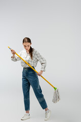 attractive girl posing like puppet isolated on grey