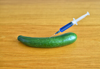 Scientist with syringe and cucumber
