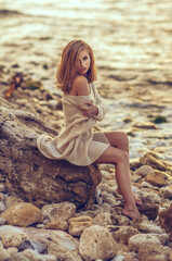 Portrait of a beautiful blond woman in a sweater in autumn outdoors