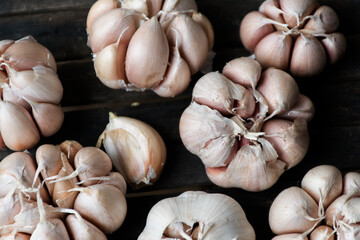 White garlic on a wooden bed, taken from above