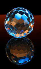 Faceted glass sphere on a black reflective surface