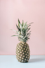 Pineapple on a pink background. Art-photo.