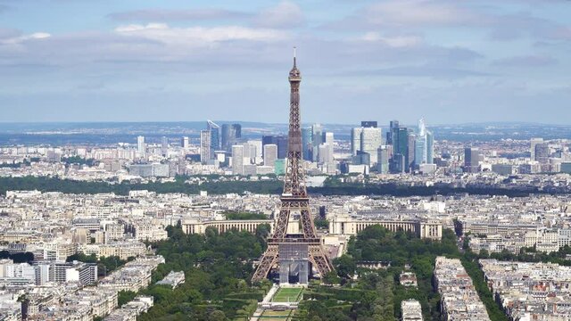 Aerial shot of the Eiffel Tower from Tour Montparnasse observation desk with the Trocadero and La Defense business district in the background - Paris, France