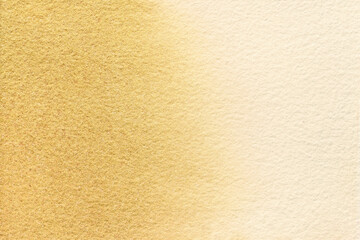 Abstract art background light beige and golden colors. Watercolor painting on canvas with soft brown gradient.