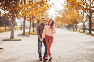 Obraz premium Young couple in love outdoor.Stunning sensual outdoor portrait of young stylish fashion couple posing in park in autumn