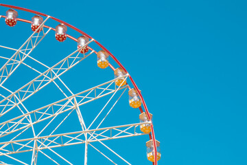 Ferris wheel against the blue sky.