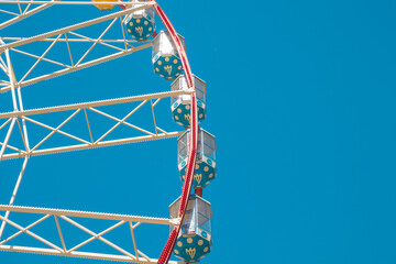 Ferris wheel against the blue sky.  Close Up View