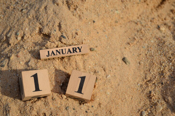 January 11, Number cube with Sand pile for a background.