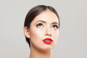 Young woman face close up on white background