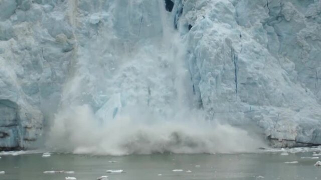 Ice calving from the glacier in Alaska due to climate change. Ice melting in Alaska, Margerie glacier.