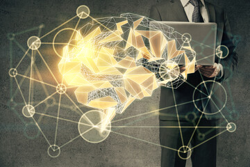 Businessman with computer background with brain theme hologram. Concept of brainstorm. Multi...