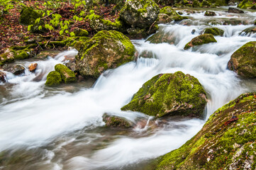 Mountain waterfall covered in fog