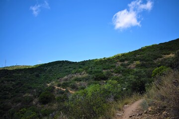 Hiking with small gravel roads, lush green mountains with clear skies