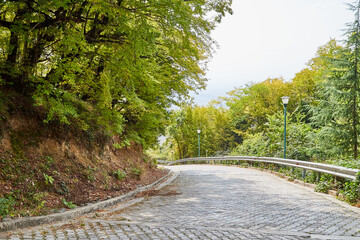 Beautiful landscape with empty old small road in the mountains in summer or autumn day