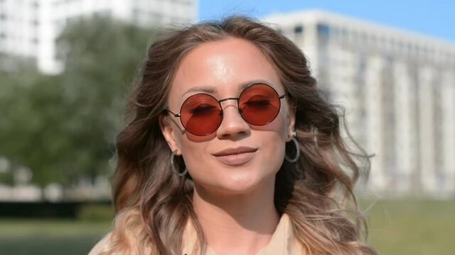 Outdoor Portrait of a beautiful caucasian girl in sunglasses hd stock footage