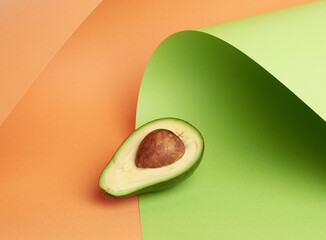 half ripe green avocado with a brown bone