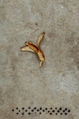 Banana peel on a concrete background. Art.