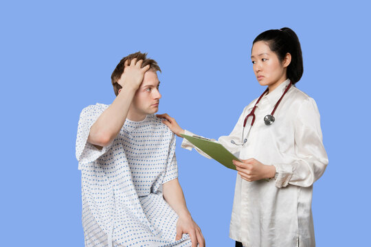 Female Asian Doctor Delivering Bad News To Patient